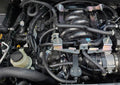 J&L 16-24 Nissan Titan 5.6L Passenger Side Oil Separator 3.0 - Black Anodized